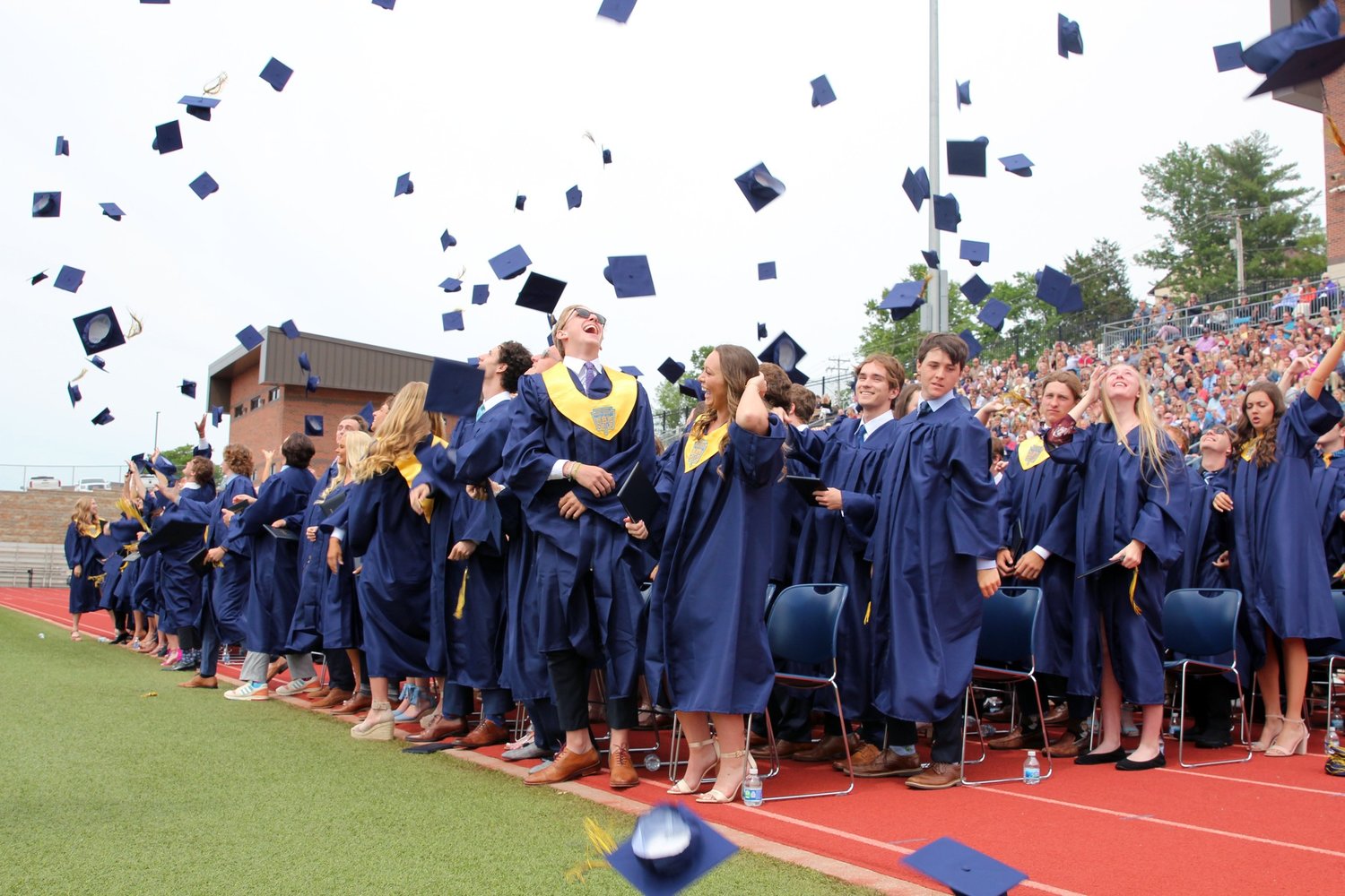 Members of Helias Catholic High School’s graduating Class of 2022 pitch their mortarboards into the air in celebration at the conclusion of their Commencement Exercises on May 22.